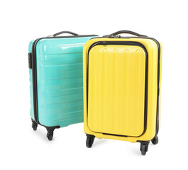 Two new yellow and light blue suitcases isolated on white