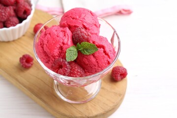 Delicious raspberry sorbet, mint and fresh berries on white wooden table, closeup. Space for text