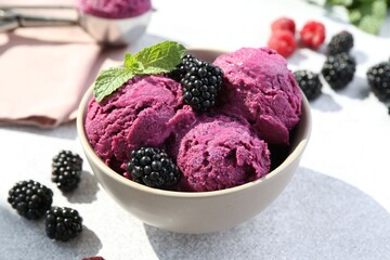 Delicious blackberry sorbet, mint and fresh berries on grey table, closeup