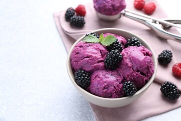Delicious blackberry sorbet, mint and fresh berries on grey table, space for text