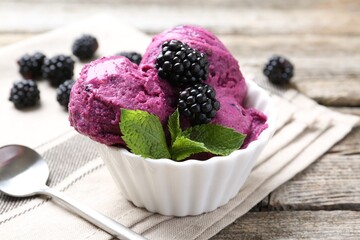 Delicious blackberry sorbet, mint and fresh berries on wooden table, closeup