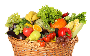 Different fresh fruits and vegetables in wicker basket isolated on white