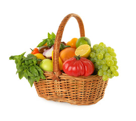 Different fresh fruits and vegetables in wicker basket isolated on white