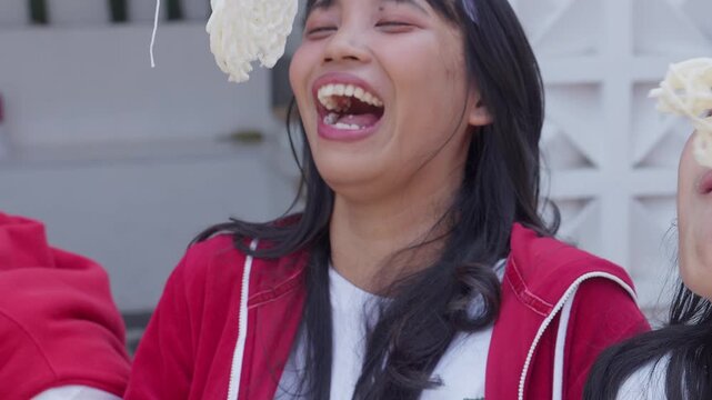 Happy Young Asian People Participating Crackers Eating Competition Called Lomba Makan Kerupuk To Celebrate Indonesian Independence Day