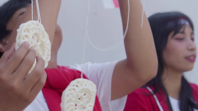 Group Of Young Asian People Prepares For Crackers Eating Competition To Celebrate Indonesian Independence Day