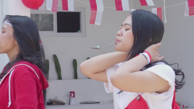 Young Asian People Participating In Spoon Marbles Race During Indonesia Independence Day Called Lomba Balap Kelereng