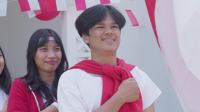 Group Of Young Man And Woman With One Clenched Fist On Their Chest To Showing Pride And Honour On Indonesia Independence Day