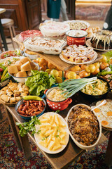 Delicious food buffet assorted on wooden table in restaurant.