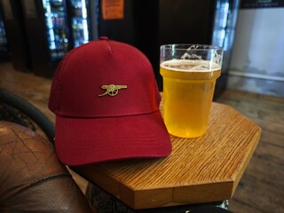 Football cap and glass of beer