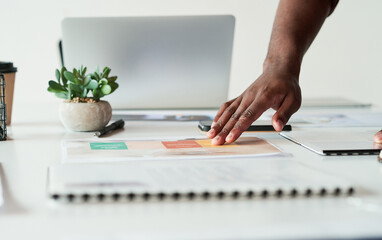 Documents, hand and creative report with information, project or review in startup. Closeup, business person and planning with paperwork, brainstorming ideas or proposal for graphic designer on table