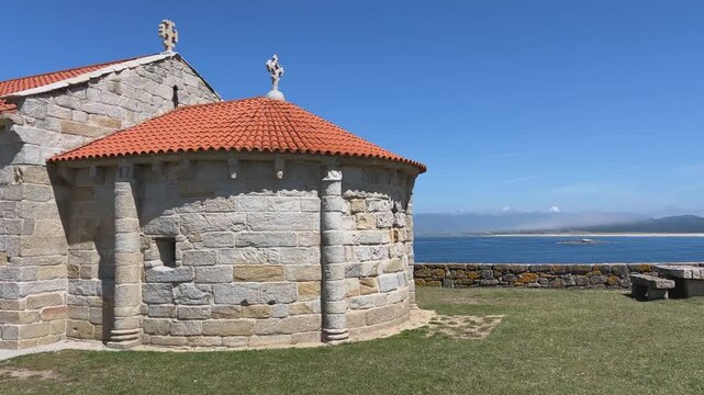 View of Ermida de Nosa Senora da Lanzada (church of Our Lady of Lanzada) in La Lanzada beach, Galicia, Spain during afternoon.