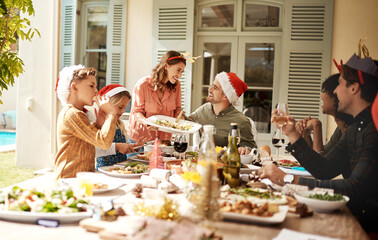 Family, smile and laugh at Christmas lunch for festive celebration, social brunch or reunion event in backyard. Happy, people and nutrition food for party, thanksgiving tradition and house outdoor