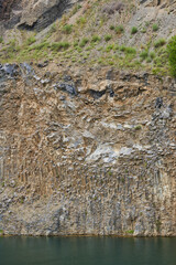 Rock formations in an abandoned quarry with a lake