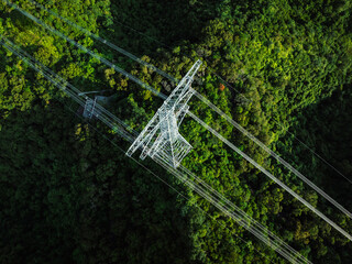 Aerial view of high voltage electric tower in forest