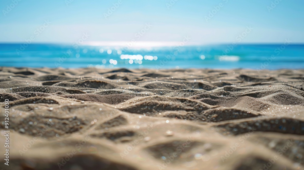 Poster a serene image of a sandy beach with the ocean stretching out behind, perfect for use in travel or r