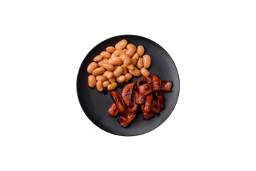 Fried sausages sliced with salt and spices as an ingredient for an English breakfast