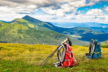 Hiking in the mountains with two backpacks in the summer.