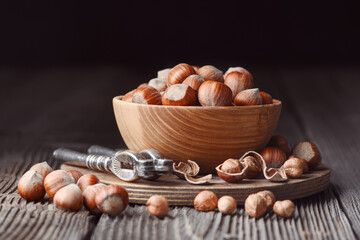 Hazelnuts and nut cracker on rustic wooden table. Food photography