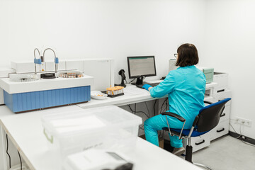 Woman, scientist and laptop with microscope in lab, microbiology and research study of organisms. Specimen, analysis and bacteria or antimicrobial.