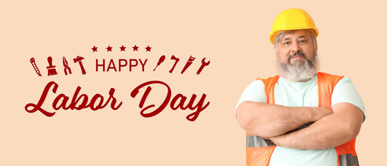 Portrait of senior man in hardhat with crossed hands on beige background. Labor Day celebration