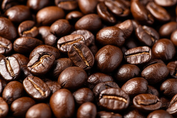 Fototapeta premium Coffee beans forming a textured background for coffee lovers