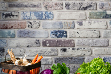 Beautiful background studio photo of fresh vegetables in front of a textured colorful brick wall