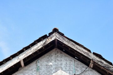 The roof of an old house made of wood and clay tiles