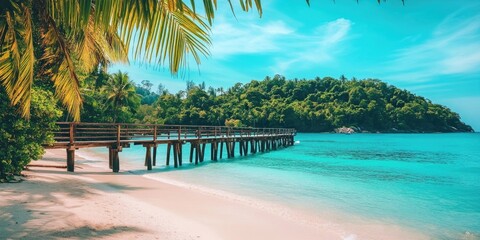 A wooden bridge spans over calm waters at a serene beach