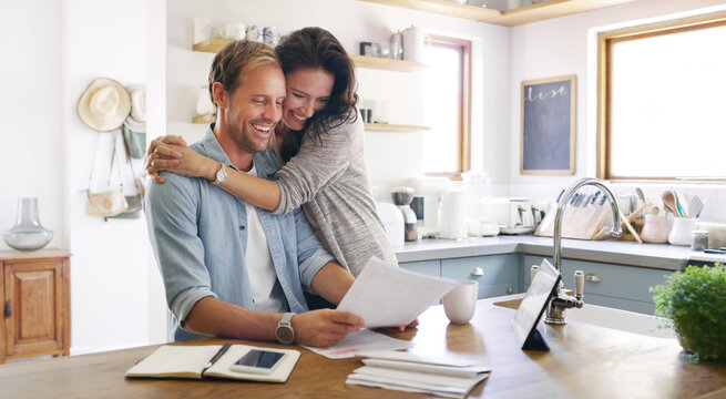 Happy, couple and hug with documents at house for financial planning, bank balance or debt payment. Man, woman or paperwork for budget savings, property insurance and credit score of loan application - Powered by Adobe