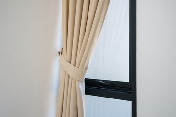 Soft beige curtain with morning sun light shining through white sheer curtain of bedroom window. new day life concept