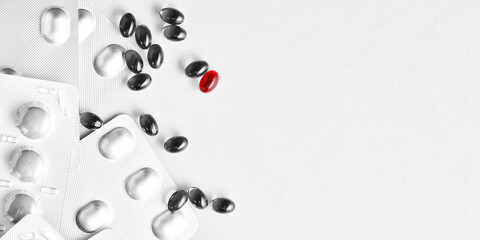 Banner with medical pills, tablets with selected red pill. Copy space with text. Vitamins, painkillers, antibiotics packages. Medicine theme