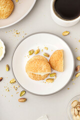 Plate with tasty choux dessert on light background
