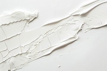 Obraz premium Thick white acrylic paint is forming an abstract pattern on a white canvas