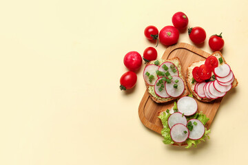 Board with delicious radish bruschettas on beige background