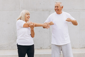 Senior Couple Exercising Together Outdoors, Engaging in Stretching Routine