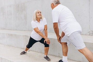 Senior Couple Exercising Together Outdoors in Matching Sportswear