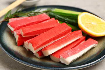 Plate with tasty crab sticks on grunge background © Pixel-Shot