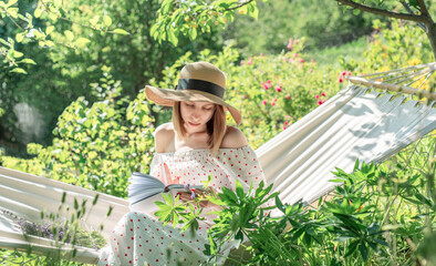 Young woman relaxing in a hammock outdoors