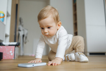 Curious Baby Playing With Smartphone at Home in Cozy Living Room