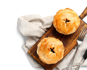 Wooden board with tasty meat pot pies on white background © Pixel-Shot