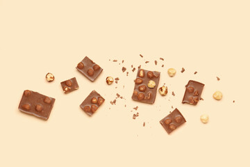 Sweet tasty chocolate with nuts on  beige background