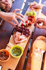Sharing a platter of appetizers outside on a sunny day
