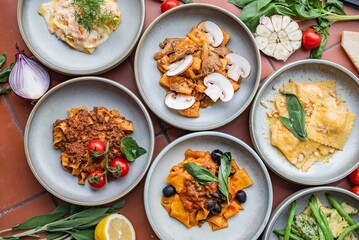 Different kinds of fresh pasta with ingredients