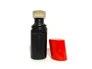 An instant shoe polisher with sponge brush applicator and red lid cover isolated on white background