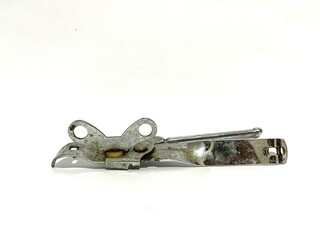 A single vintage tin can opener tool made from metal with rotating key winder isolated on white...
