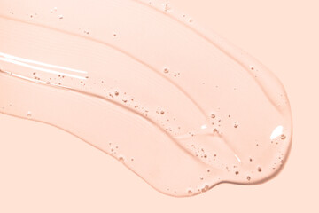 Cream gel pech pink transparent cosmetic sample texture with bubbles isolated on white background