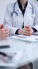 Doctor and patient are sitting and talking at the glass table, Medicine and health care concept