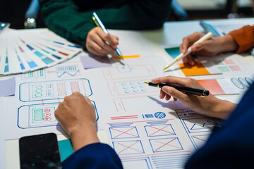 Creative digital development agency. developer team brainstorming on their project with laptop,...