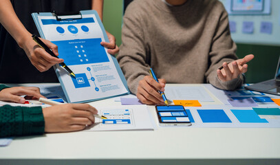 Creative digital development agency. developer team brainstorming on their project with laptop,...