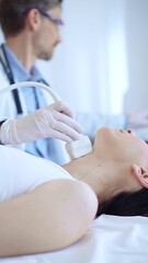 Obraz premium Doctor man wearing white protective gloves is using ultrasound machine to examine neck of female patient in hospital. Medicine, thyroid gland health